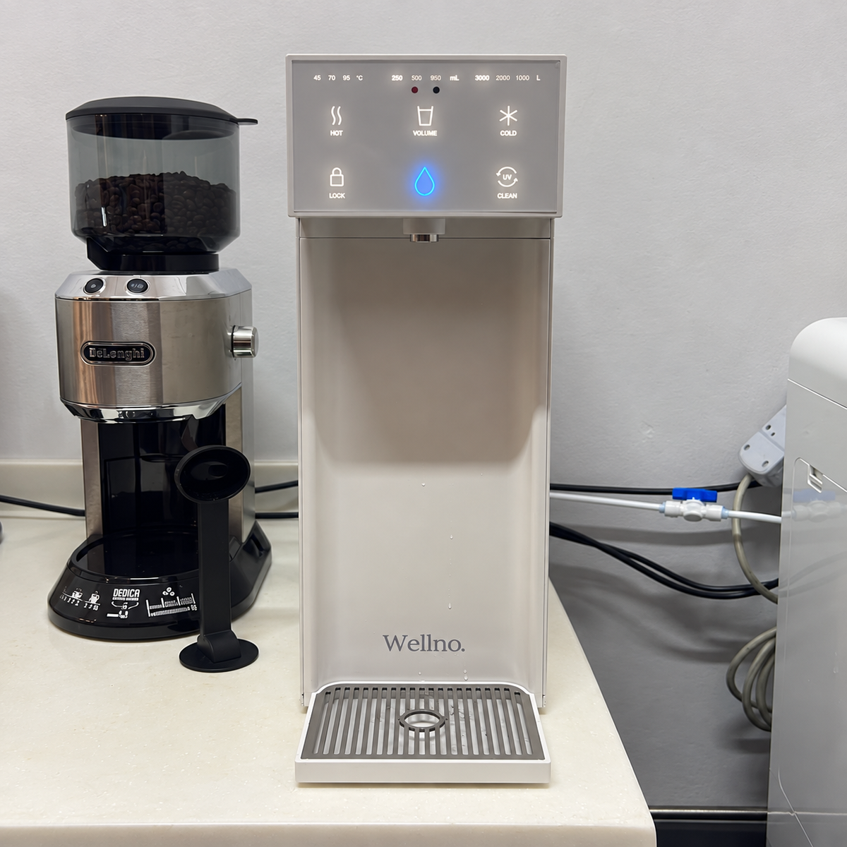 Customer photo of a white Wellno Flo next to a coffee grinder